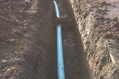 The blue pipe in the lower trench.